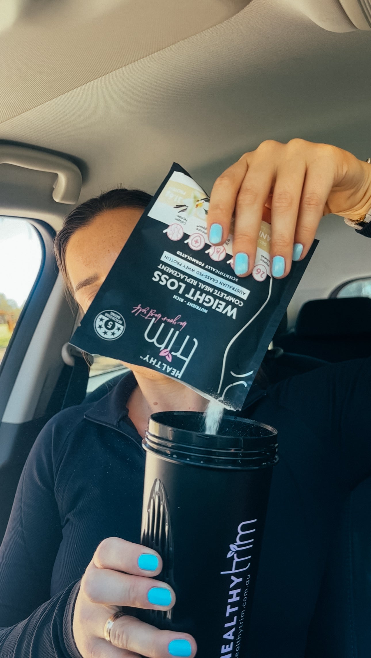 Lady pouring sachet into a shaker.
